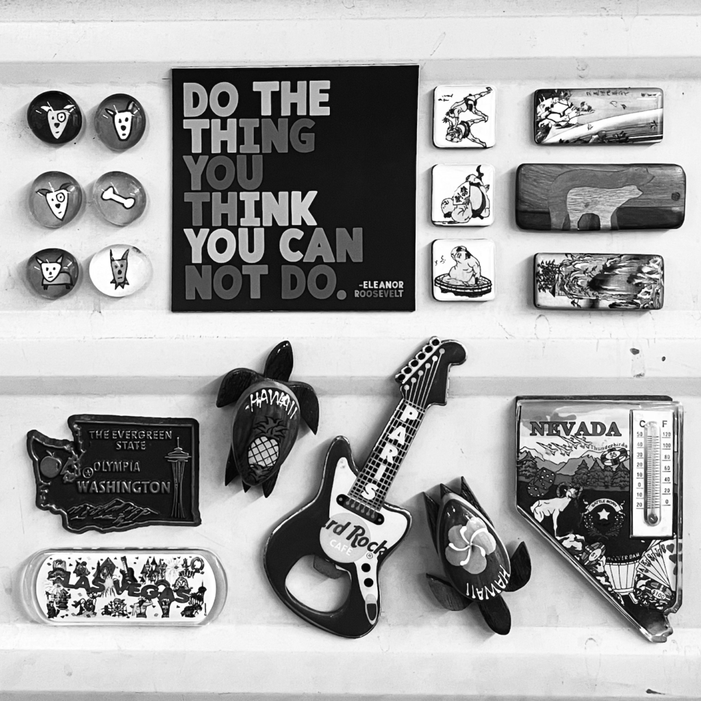 Collection of vintage items and a sign with a quote from Eleanor Roosevelt saying "Do the thing you think you can not do."